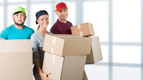 Professional movers loading household items on a Streatham street