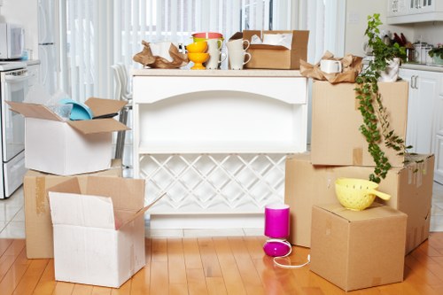 Professional movers handling office furniture in a South London street