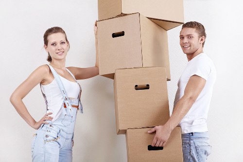 Packed moving boxes and furniture ready for transport in Streatham